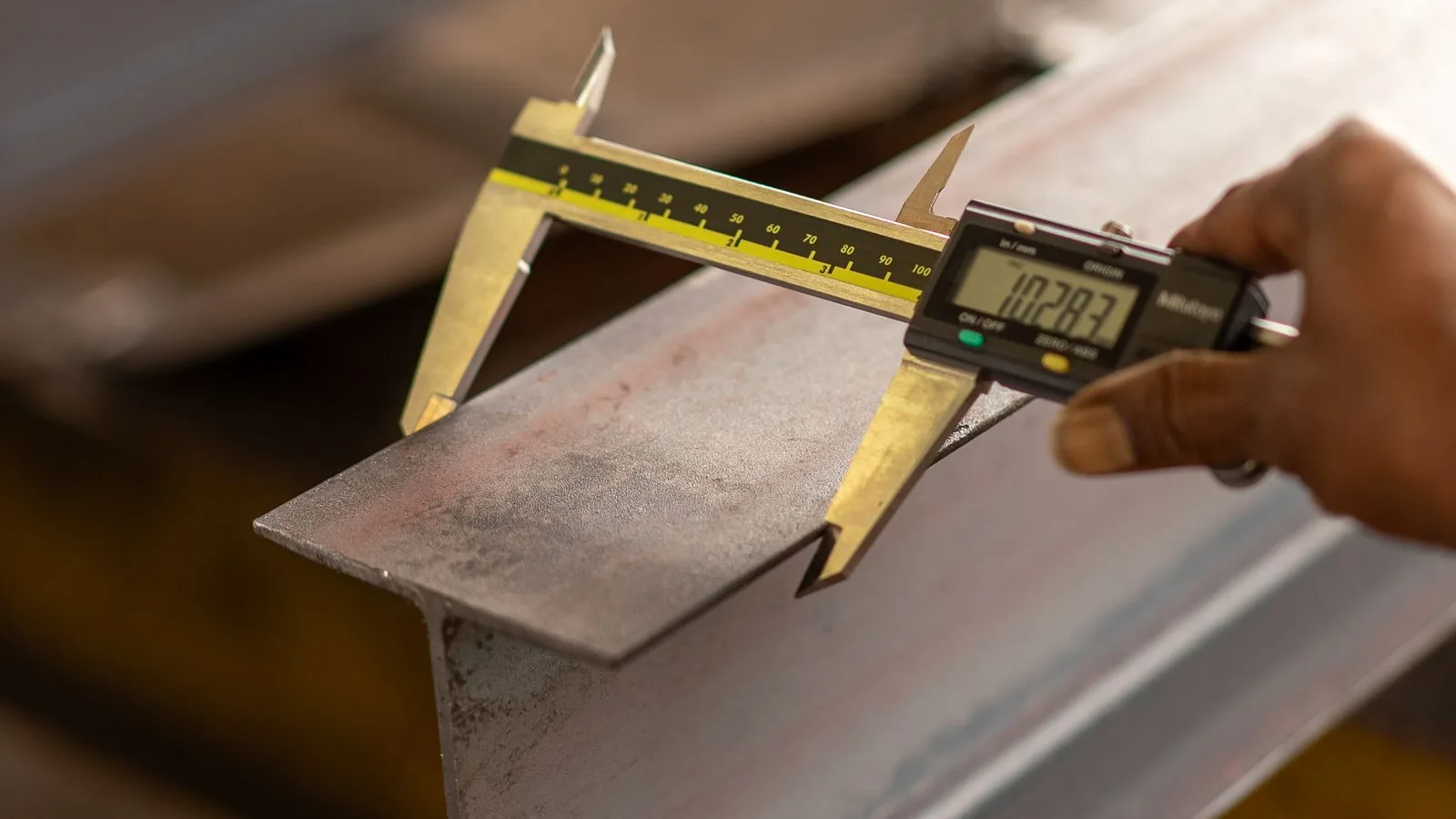 Precision calipers measuring a steel component
