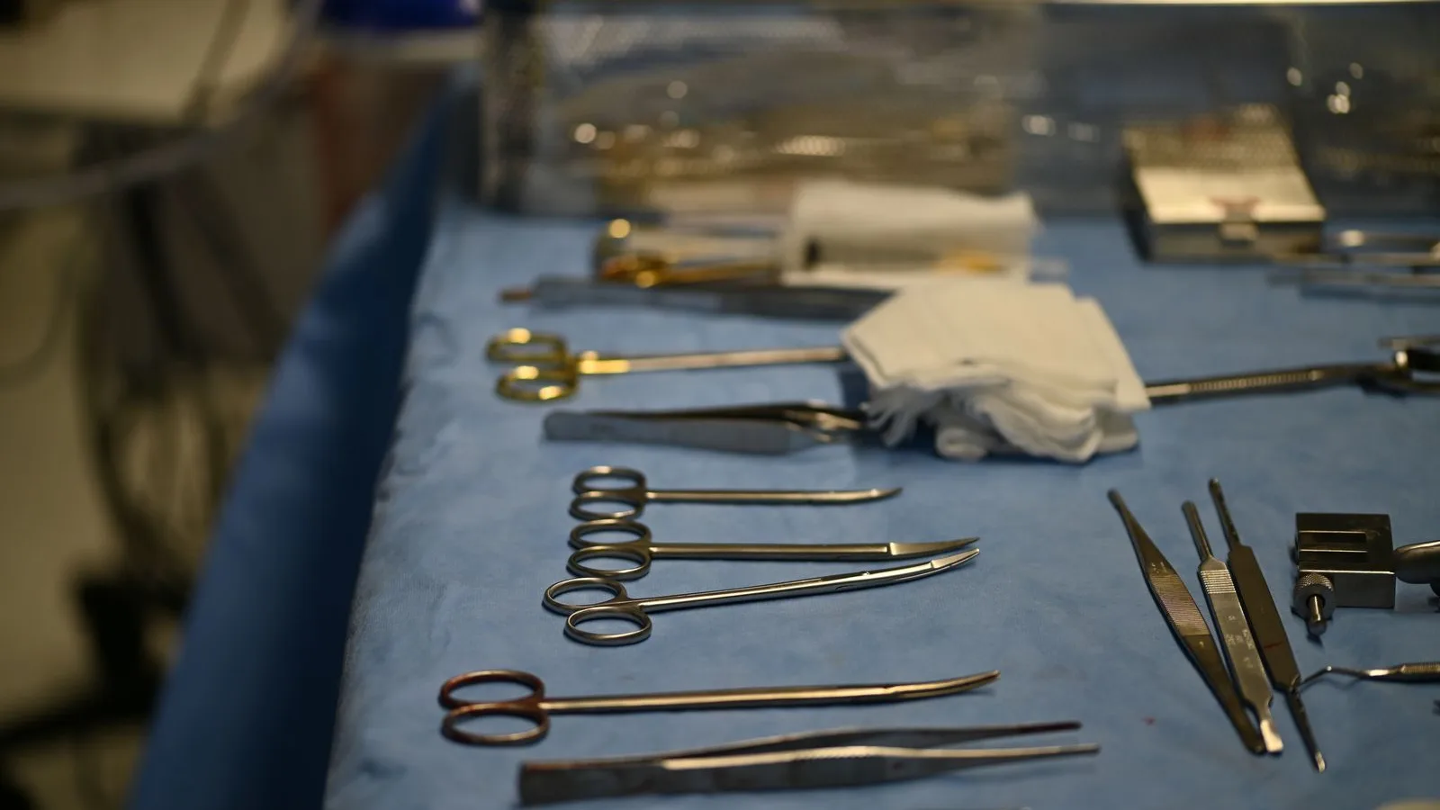 Sterile surgical instruments arranged on a blue table